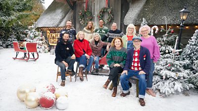 The Repair Shop experts sit on stools outside the building, with a covering of white powder on the ground