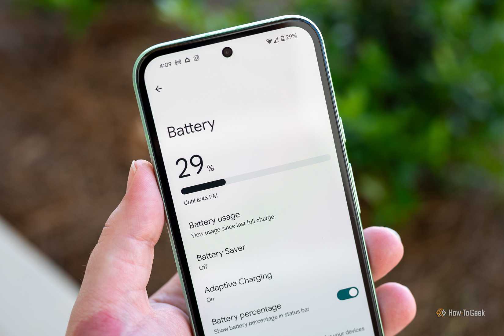 Person holding the Google Pixel 8a showing the Battery menu