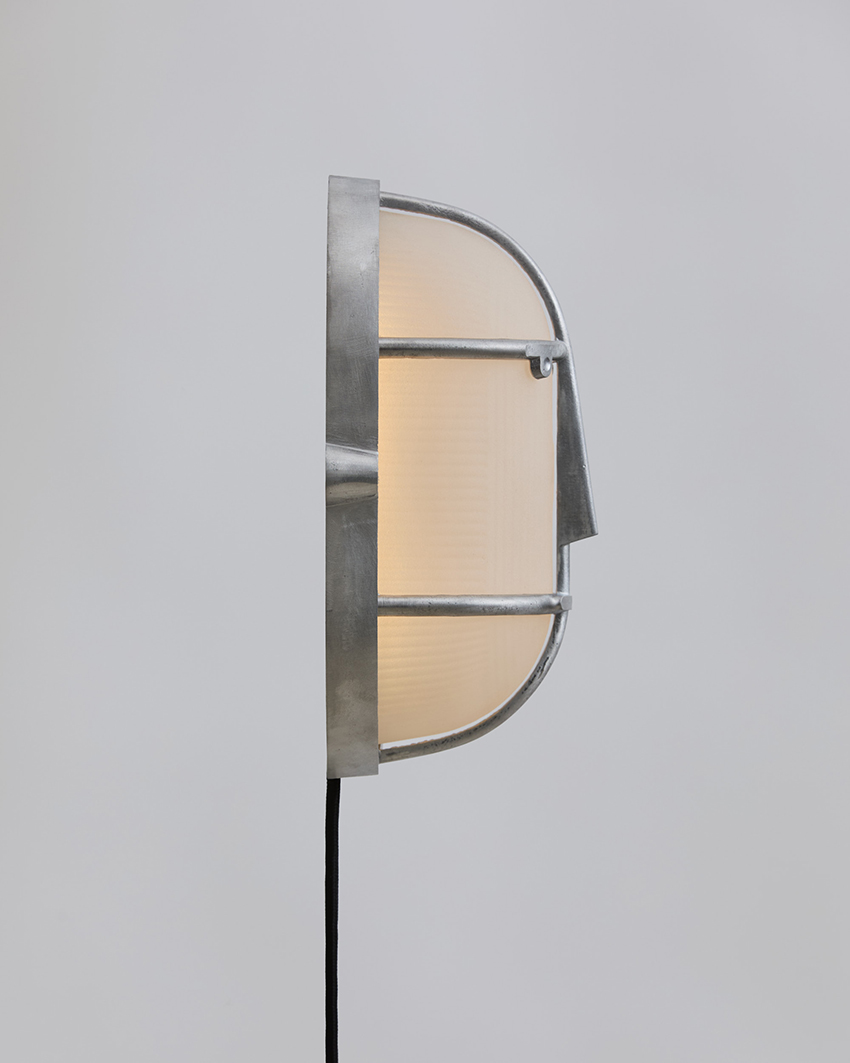 philippe tabet reimagines industrial bulkhead lamp as face-like lighting fixture