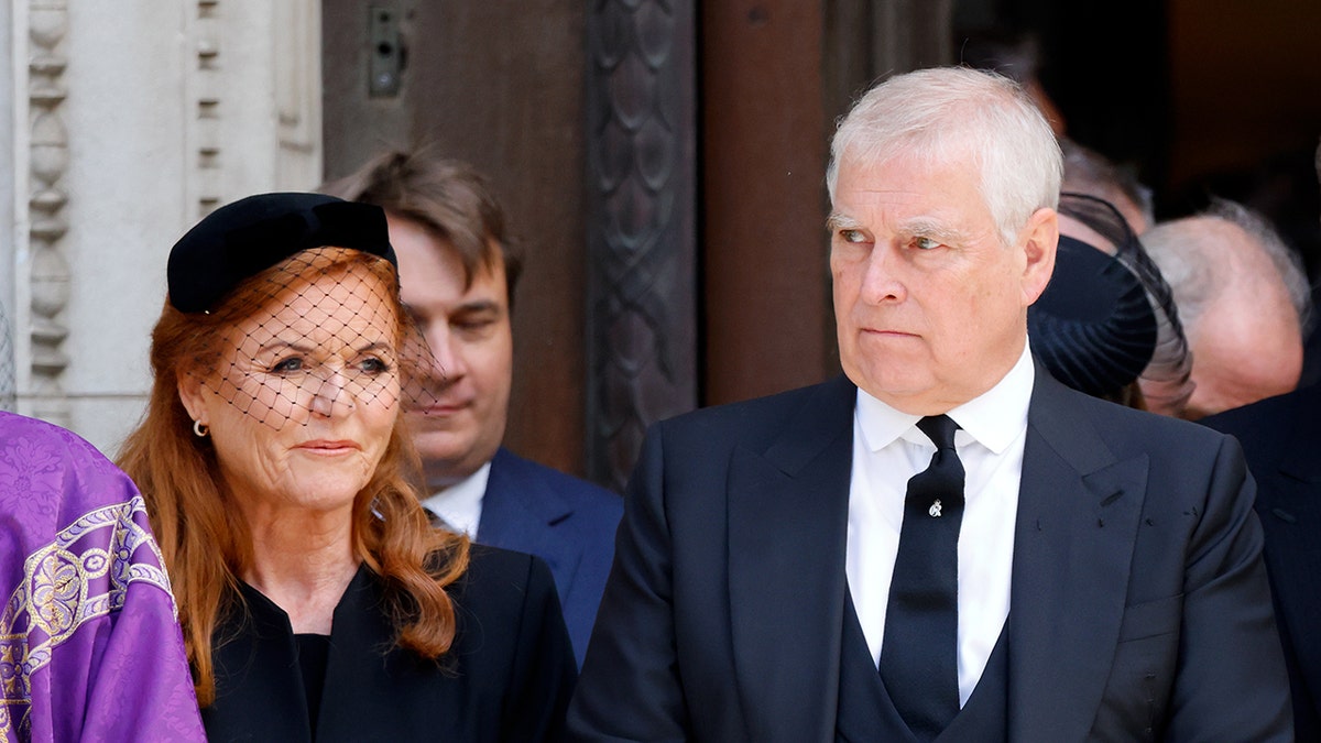 Sarah Ferguson looking somber walking alongside Prince Andrew outside of church.