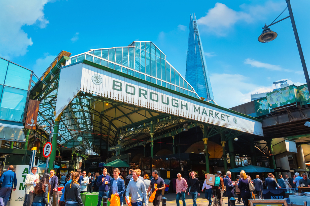 Entrance to a bustling Borough Market with the Shard in the background.