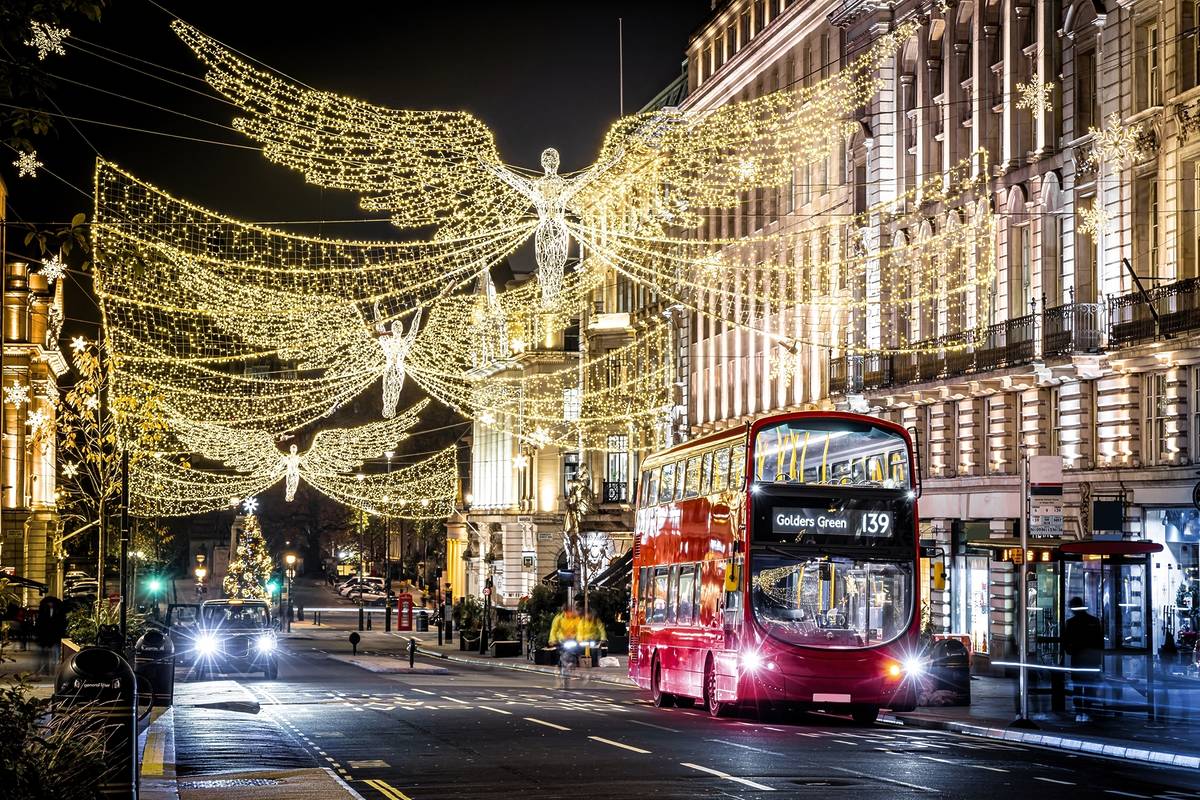 the 139 bus driving underneath the christmas lights on regent street at night