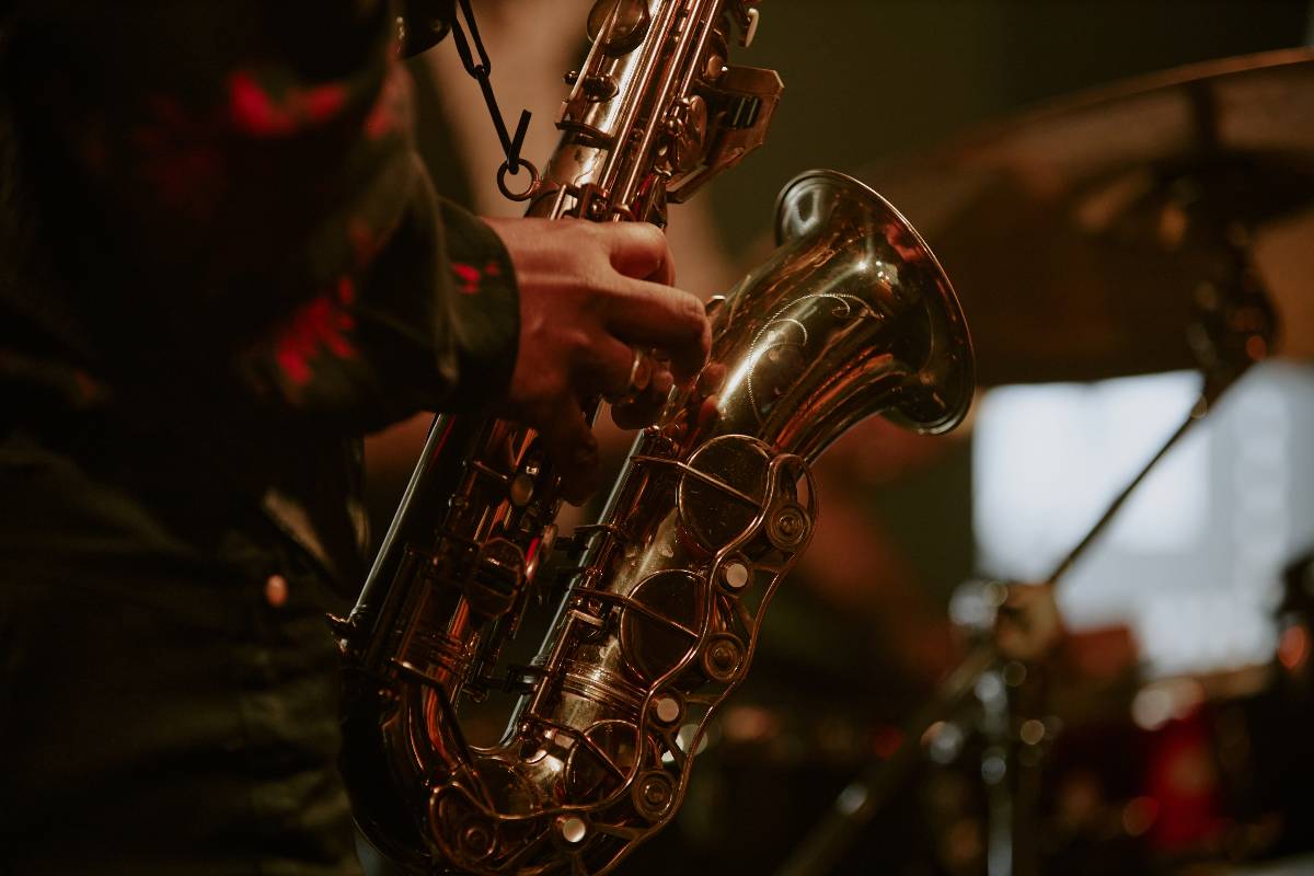 A person playing a saxophone on stage at a jazz show