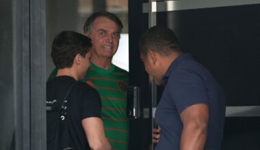Jair Bolsonaro comes to the door during his house arrest in Brasilia on Friday. Pic: Reuters