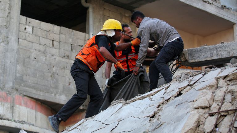 A man is helped to safety in Gaza City. Pic: Reuters