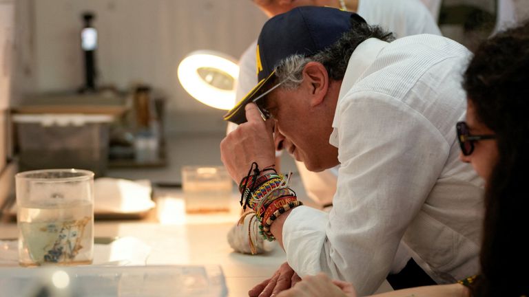Colombian President Gustavo Petro inspects a porcelain bowl from the wreck. Pic: Reuters