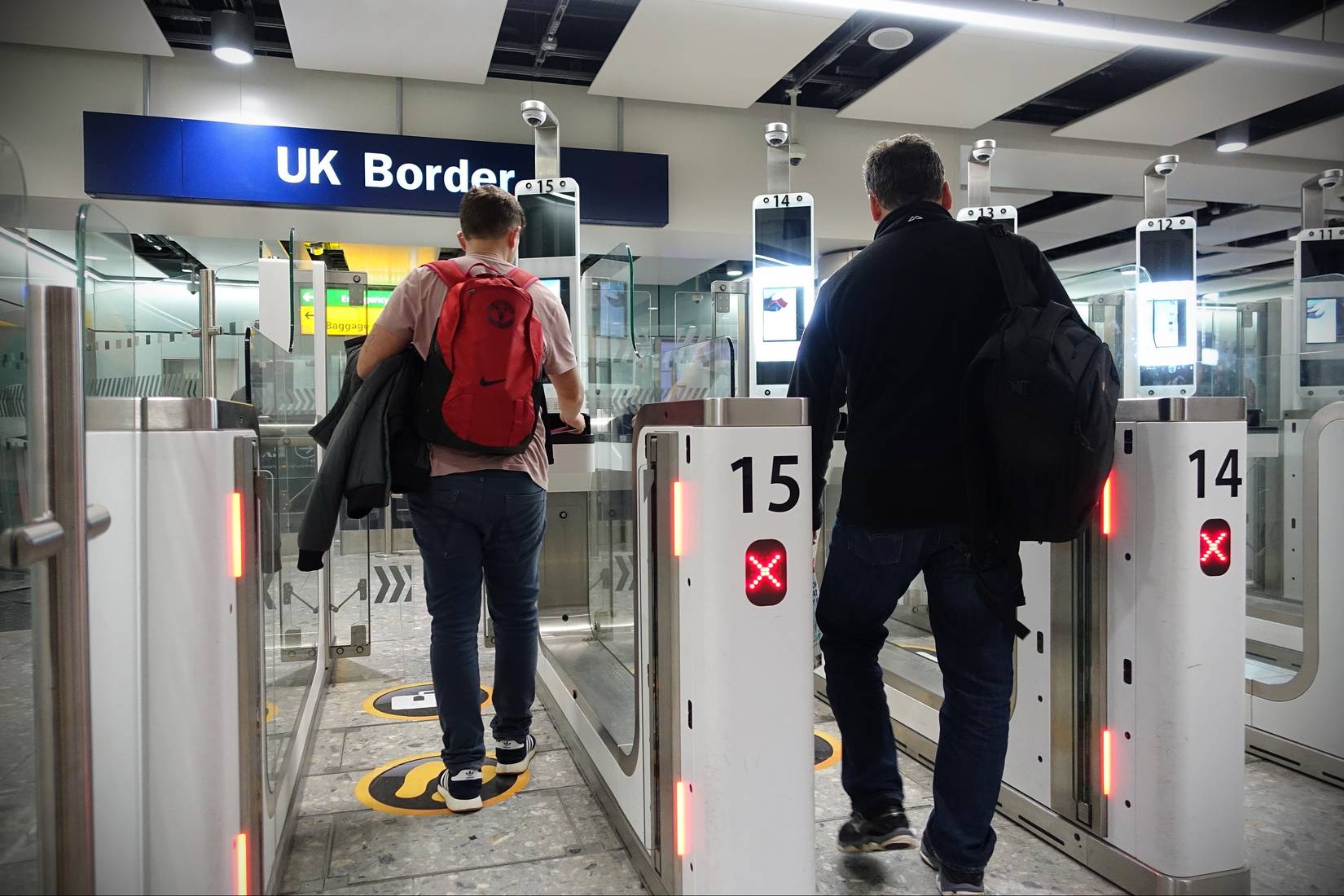 Travelers pass through automated passport border control e-gates at Heathrow Airport's UK Border Force in London, United Kingdom, UK