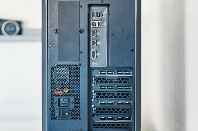 Alongside the motherboard's rather spartan I/O, we see the sixteen QSFP-DD cages used to mesh the four P150s together. Alongside the motherboard's rather spartan I/O, we see the sixteen QSFP-DD cages used to mesh the four P150s together.
