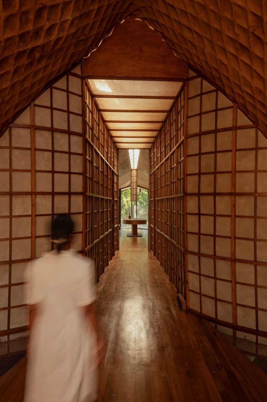 Person walking through the Bridge House by Wallmakers