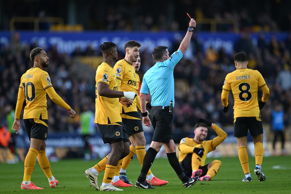 WOLVERHAMPTON, ENGLAND: Referee Michael Oliver shows a red card to Myles Lewis-Skelly of Arsenal (not pictured) after he fouled Matt Doherty of Wolverhampton Wanderers (obscured) during the Premier League match between Wolverhampton Wanderers FC and Arsenal FC at Molineux on January 25, 2025. (Photo by Shaun Botterill/Getty Images)