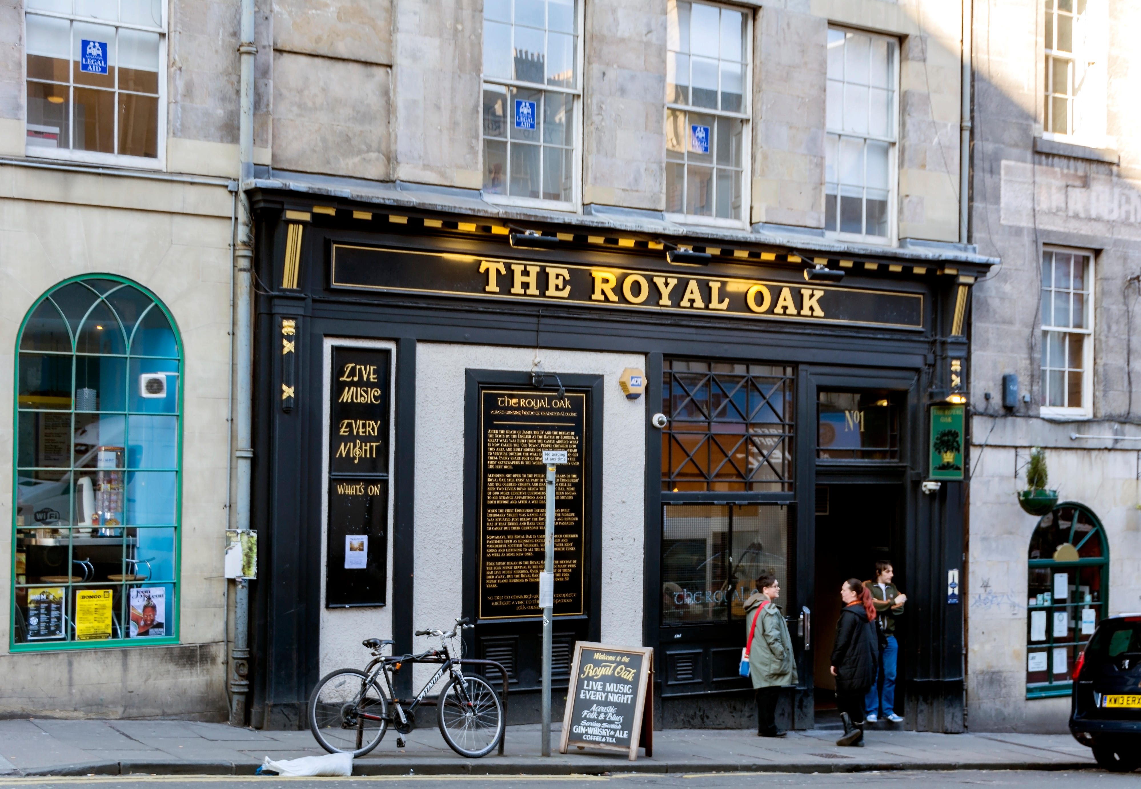 The Royal Oak pub with signs advertising live music and folk music.