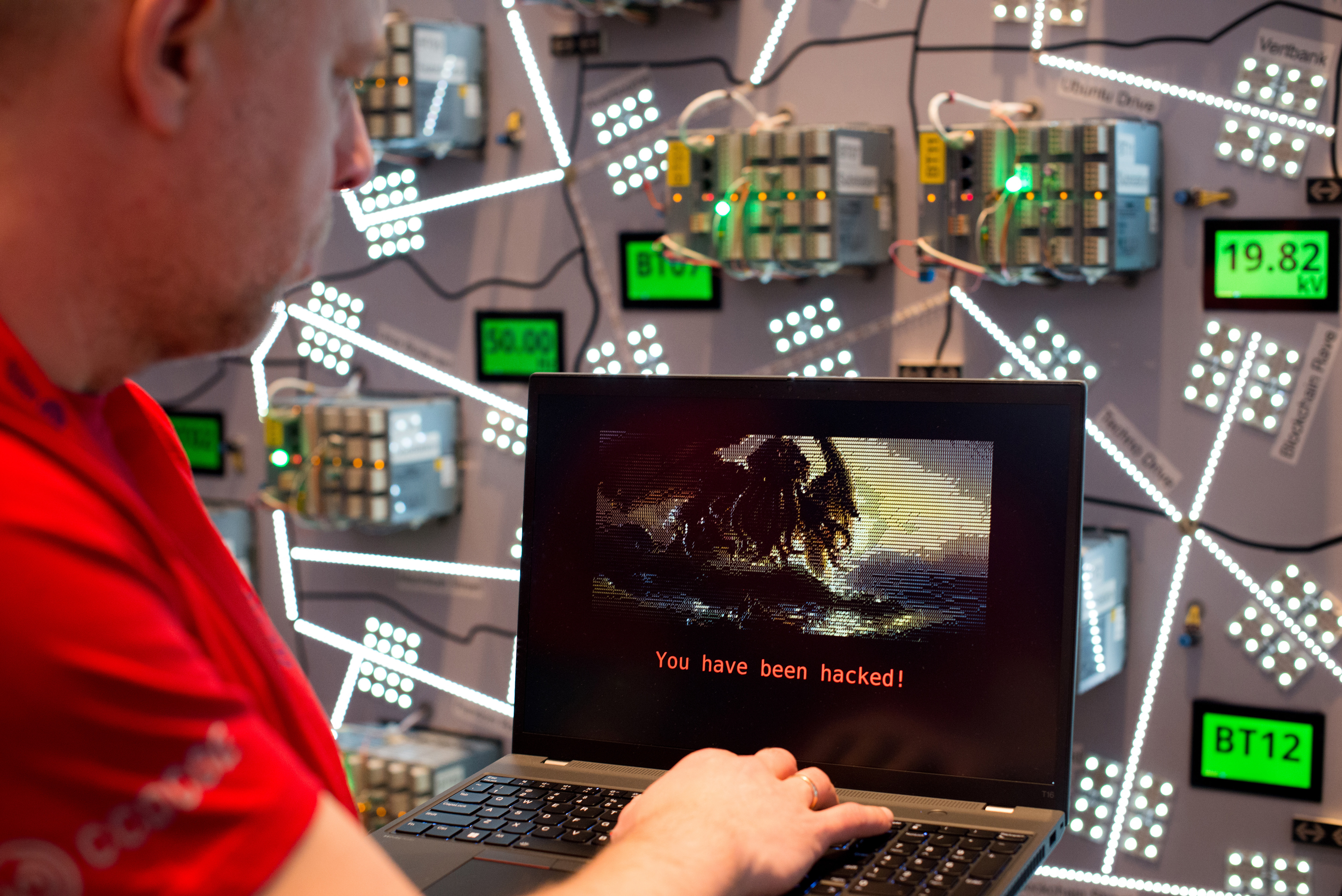 A participant working on a laptop displaying "You have been hacked!" during the Locked Shields cyber defense exercise.