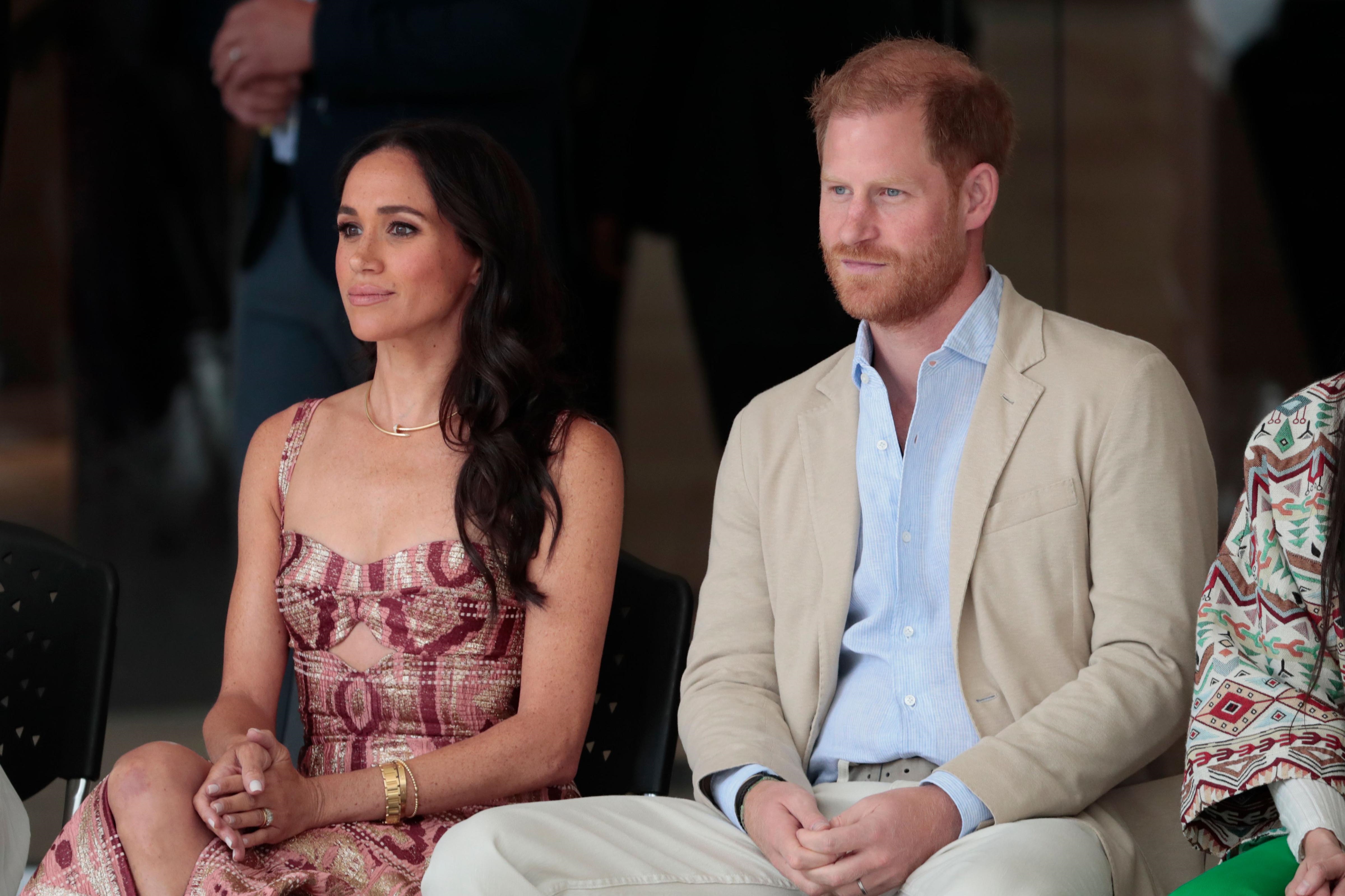 Meghan, Duchess of Sussex, and Prince Harry, Duke of Sussex, seated at an event.