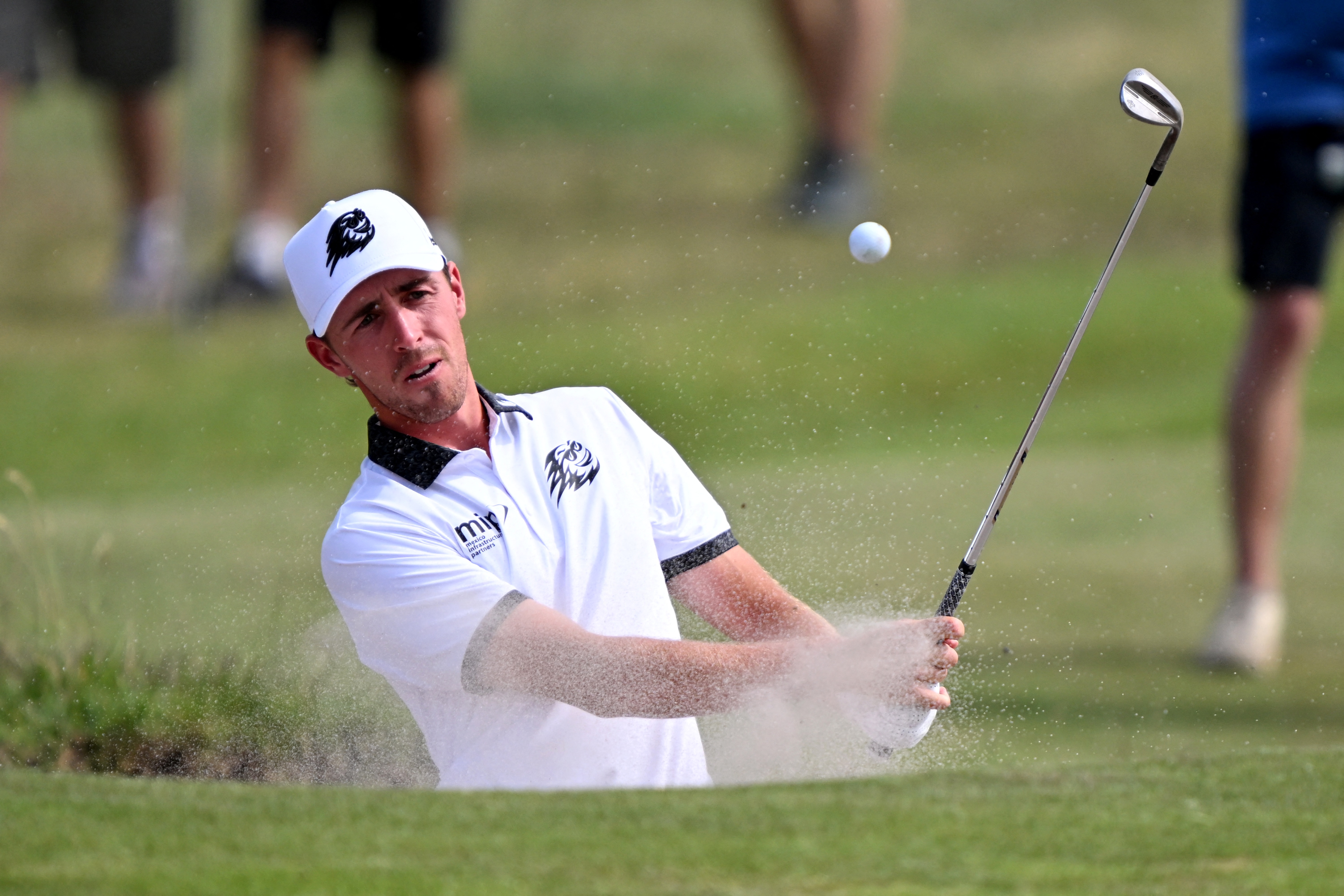 David Puig of Spain hits out of a bunker during the first round of the Australian Open golf tournament.