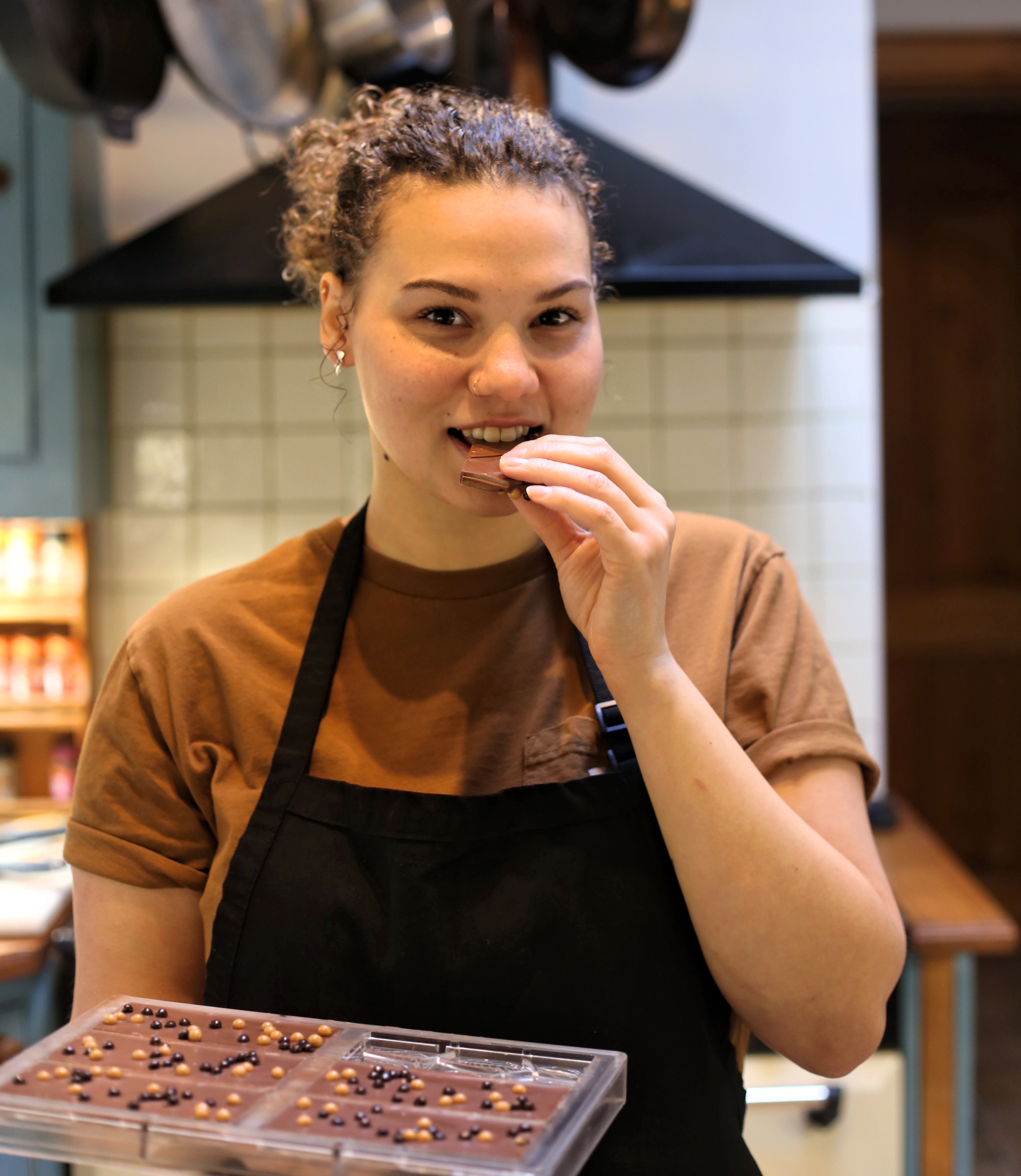 Chloe Oswald eating a piece of chocolate from Chocolatia.