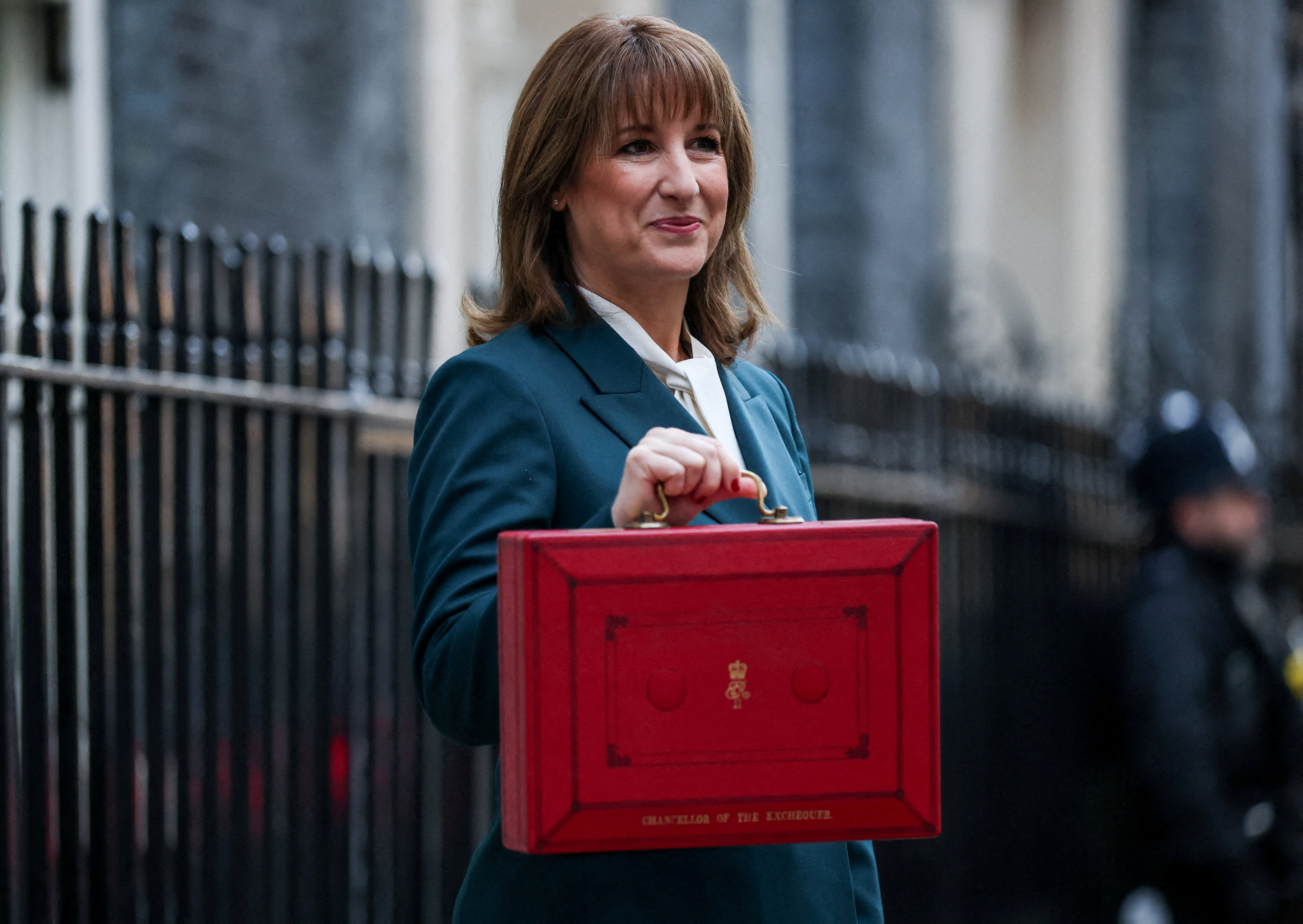 British Chancellor of the Exchequer Rachel Reeves poses with the red budget box outside her office in Downing Street.