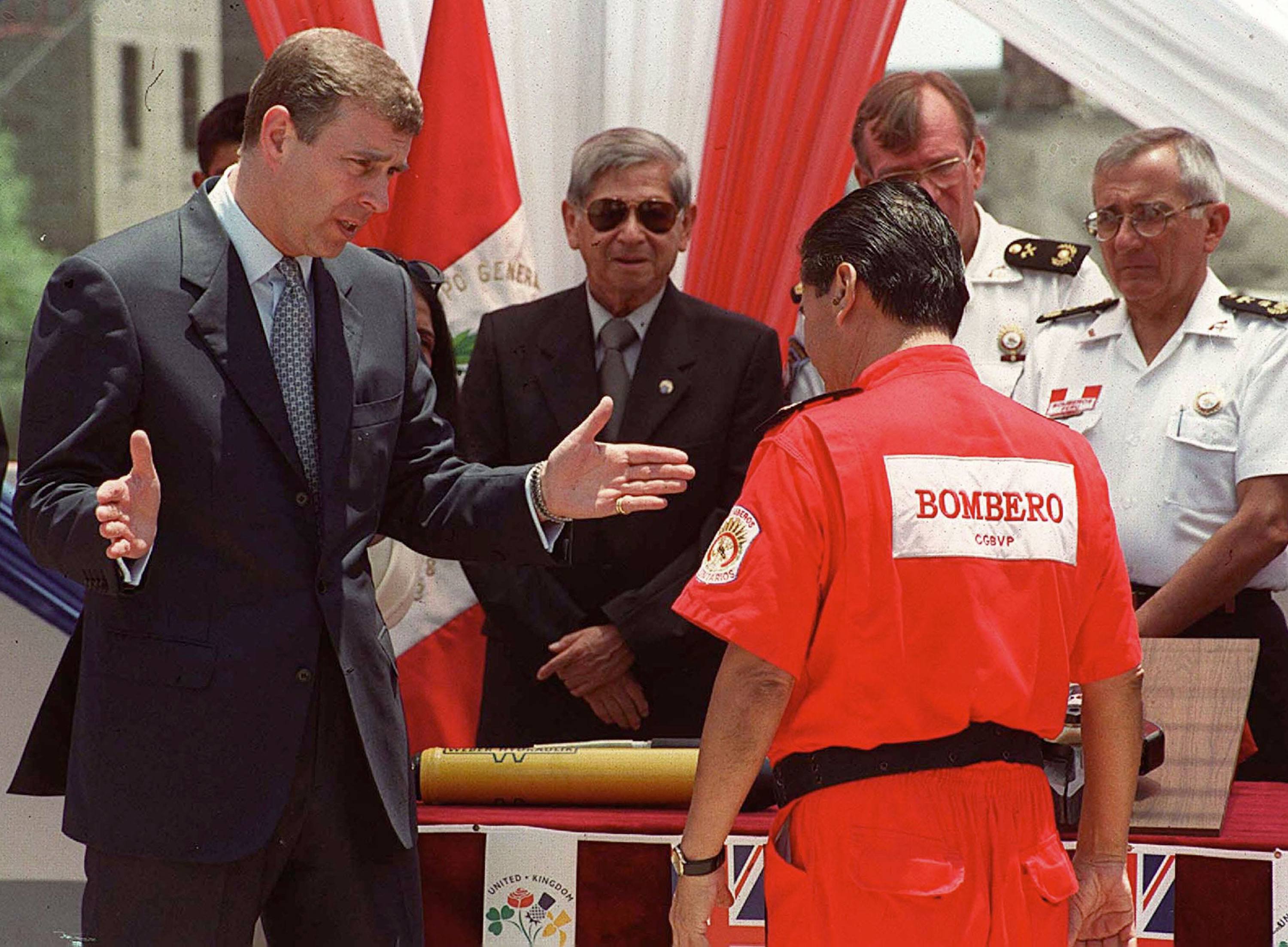 Prince Andrew speaking with a Peruvian firefighter.