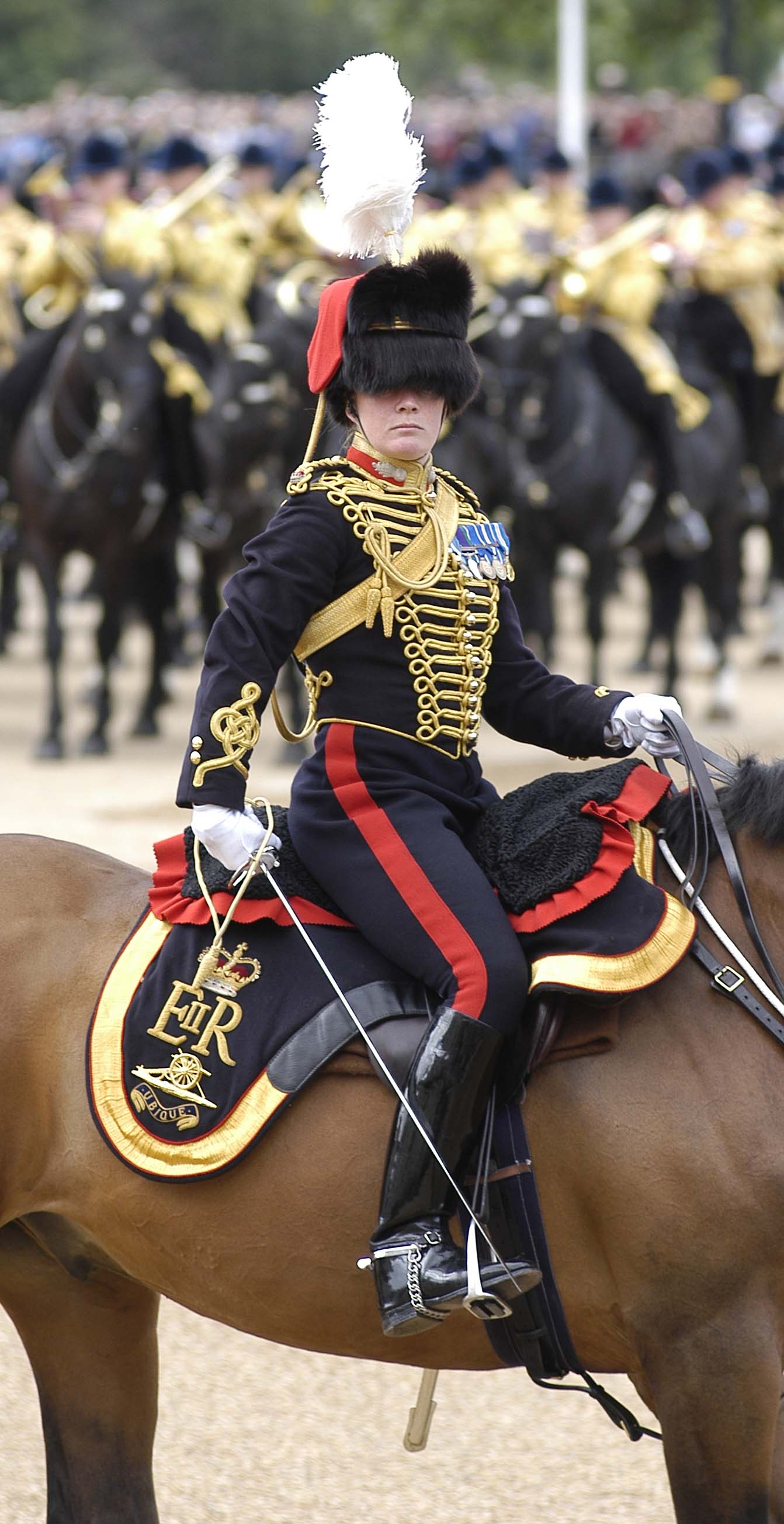 Major Erica Bridge riding a horse while taking part in the Trooping of the Colour.