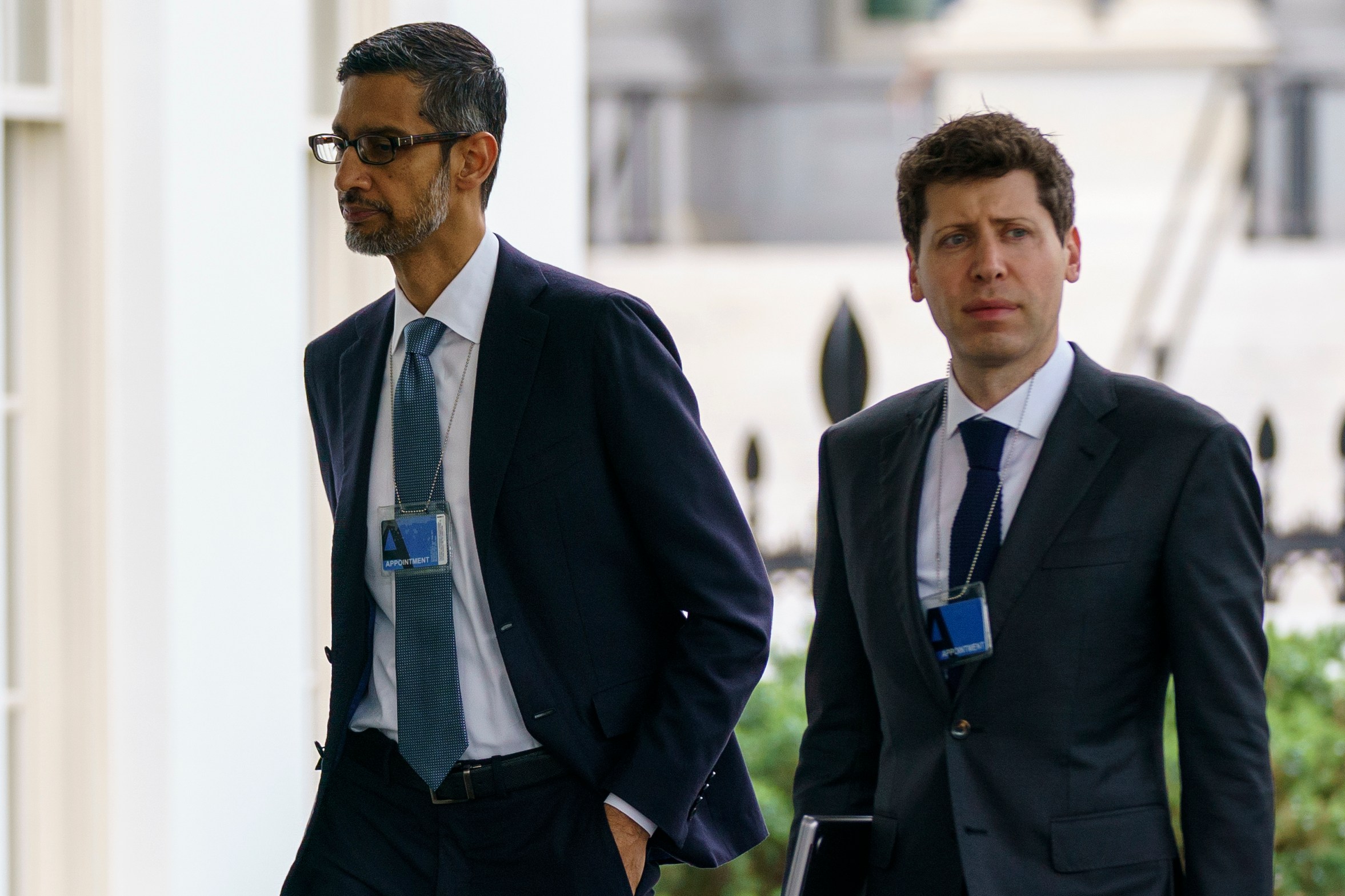 Alphabet CEO Sundar Pichai and OpenAI CEO Sam Altman walking at the White House.