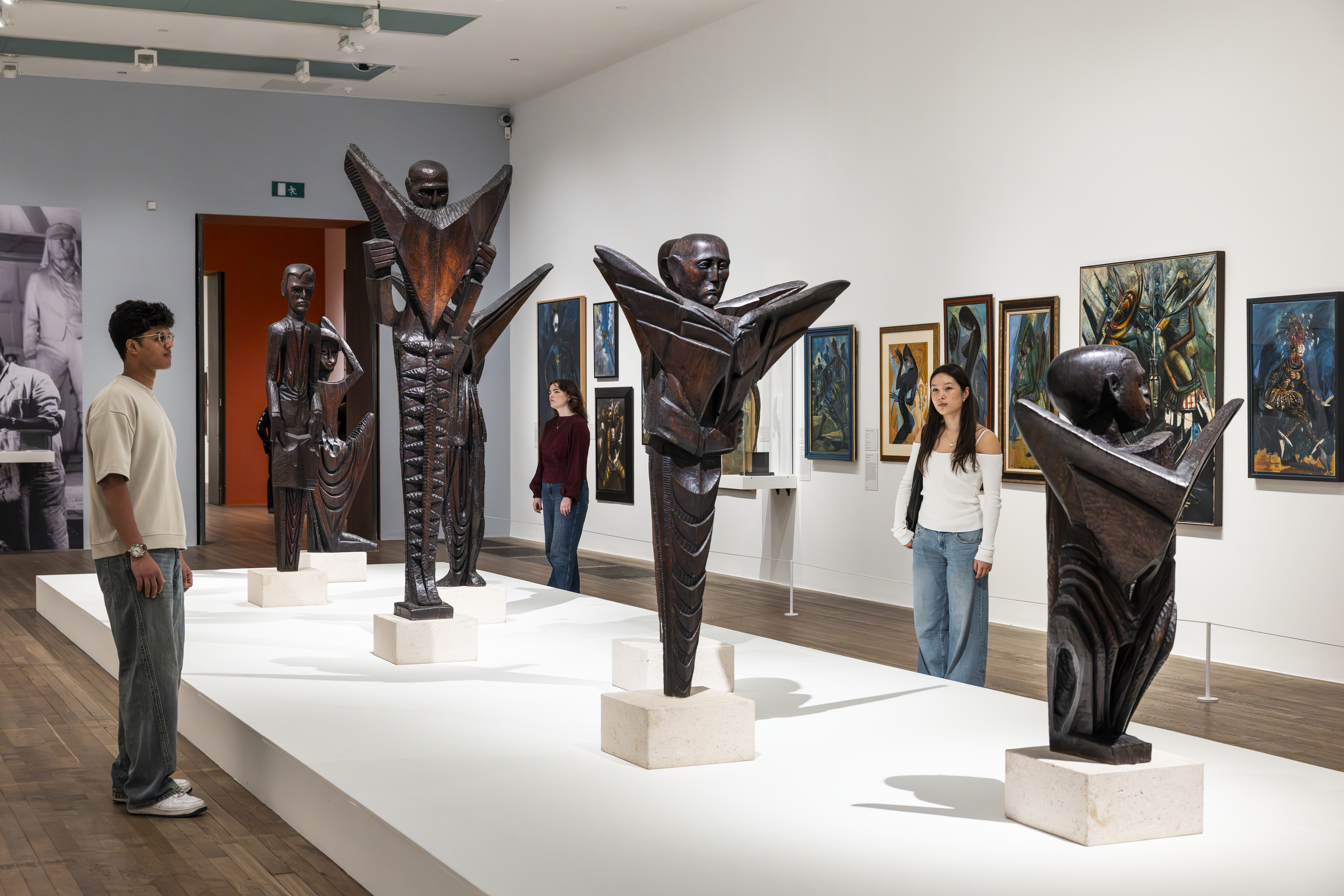 Visitors viewing Nigerian modernist sculptures and paintings at the Tate Modern.