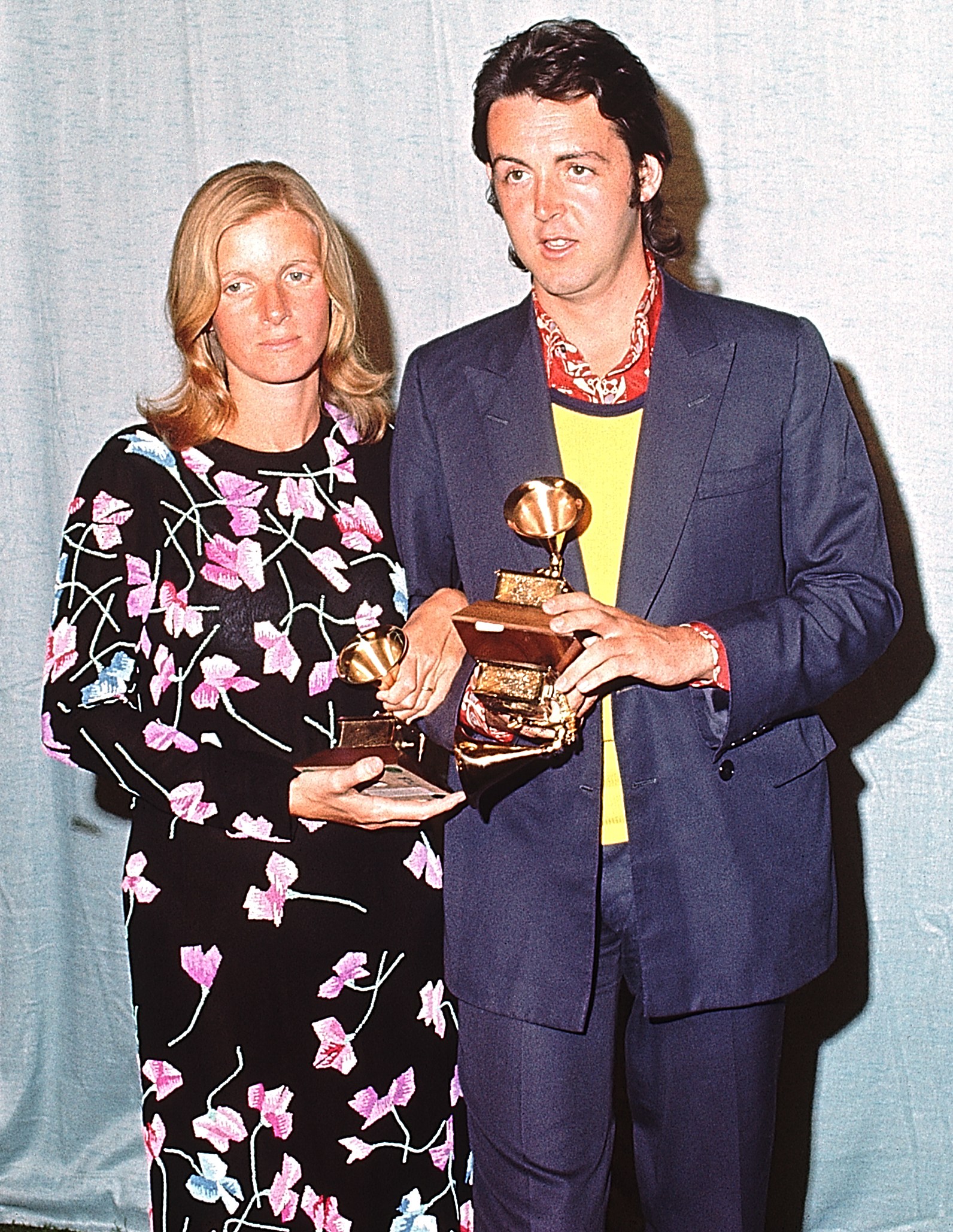 Paul and Linda McCartney at the Grammy Awards ceremony holding their awards.