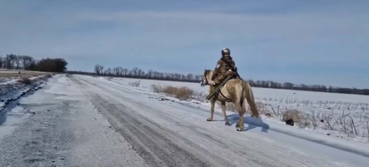 Russian soldier on horseback in a snowy landscape.