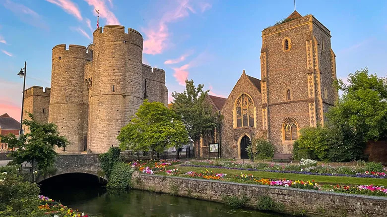 Colorful sunset clouds over medieval Westgate Towers and Guildhall in Canterbury with the River Stour in front