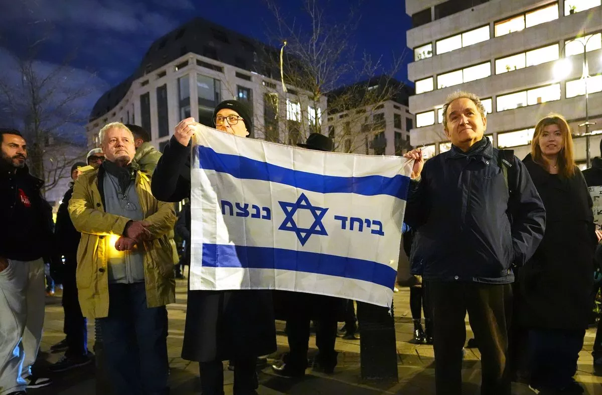 People hold a vigil outside the Australian High Commission in central London, following the terrorist attack targeting a Jewish celebration at Bondi Beach in Sydney, Australia, where at least 12 people have been killed. 