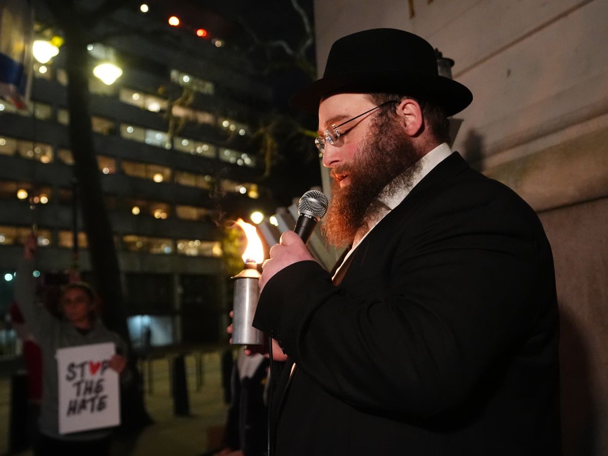 A rabbi lights a menorah during a vigil outside the Australian High Commission in central London, following the terrorist attack targeting a Jewish celebration at Bondi Beach in Sydney, Australia, where at least 12 people have been killed. 