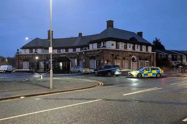 A police cordon outside the Oak Tree pub in Huyton after someone was shot in the leg on nearby Radway Road
