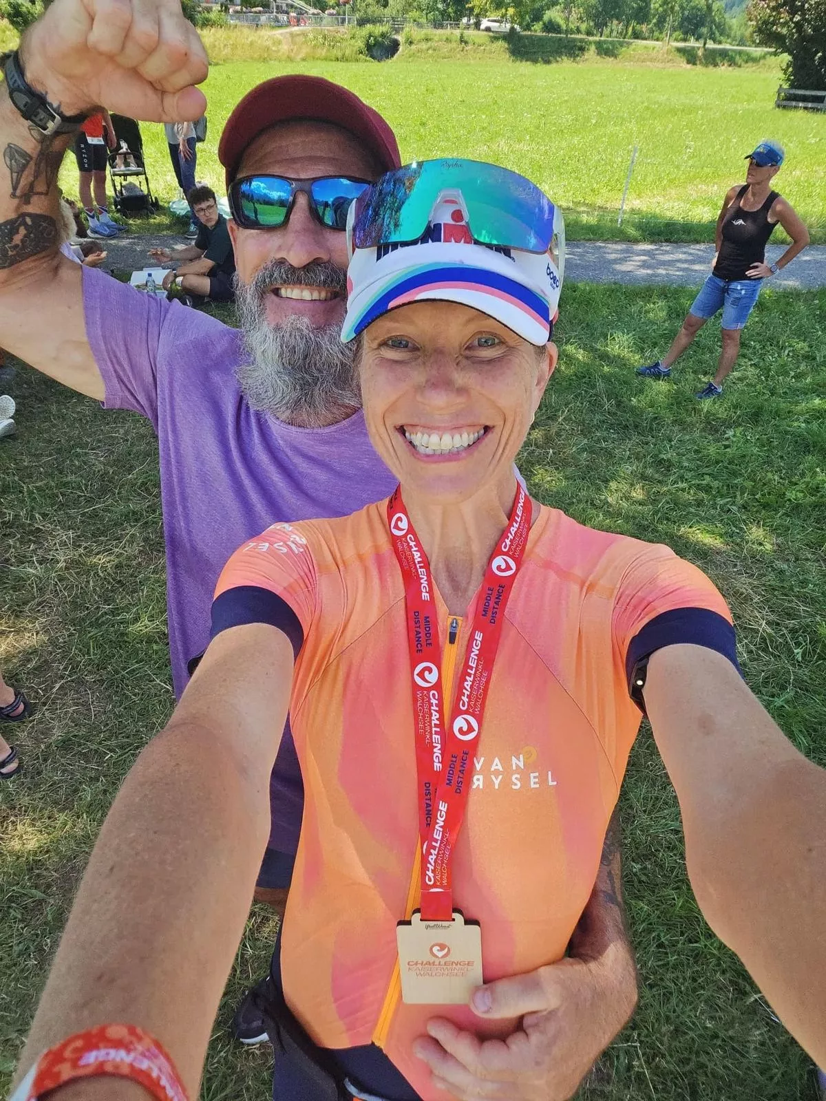 A man and woman stand next to one another smiling