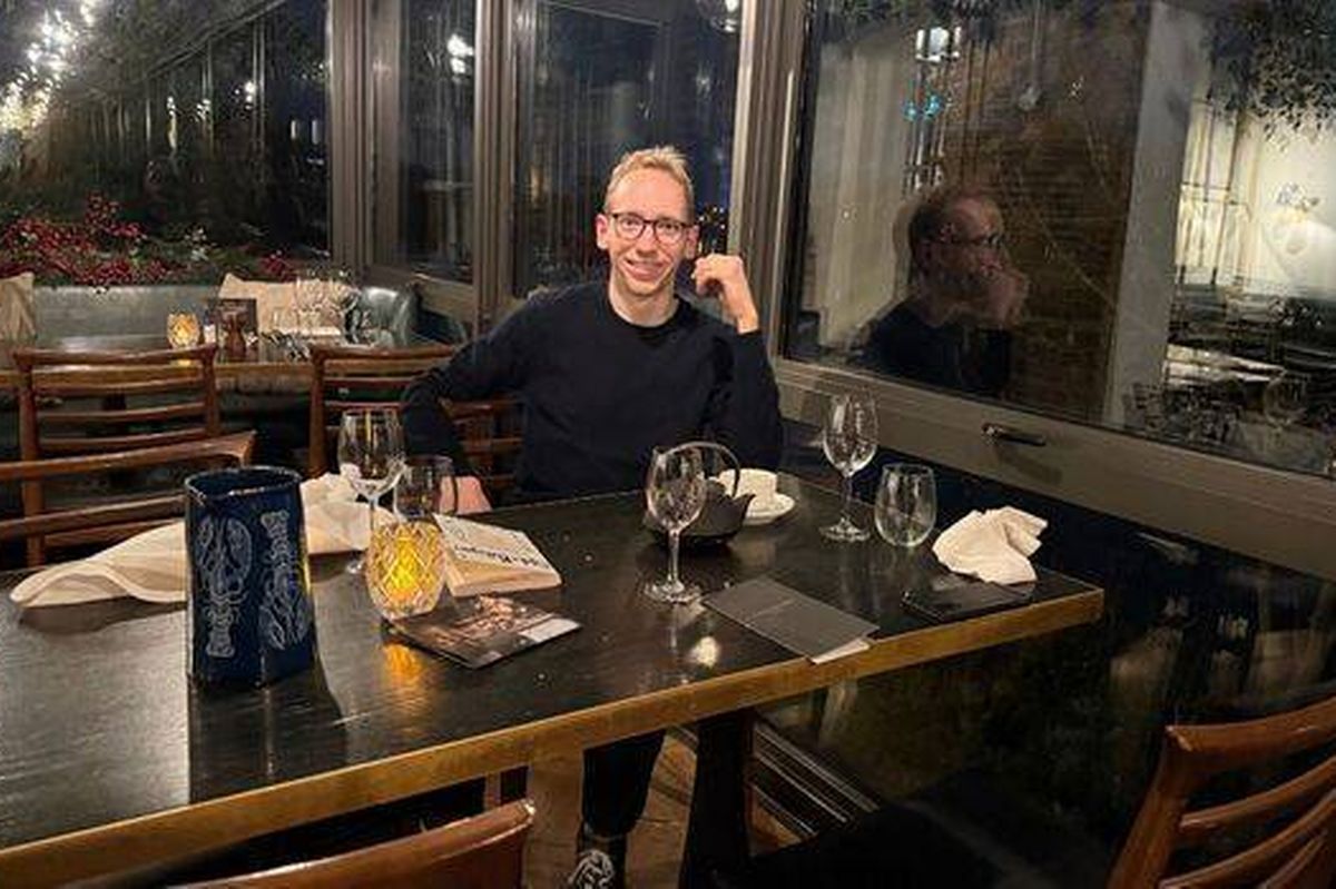 Christopher Sharp sitting at a table