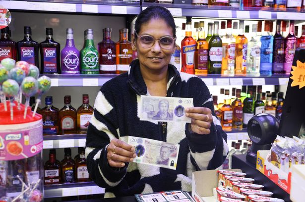 Shopkeeper Perpetina Lourdusamy, 56, with counterfeit banknotes in her store on County Road.