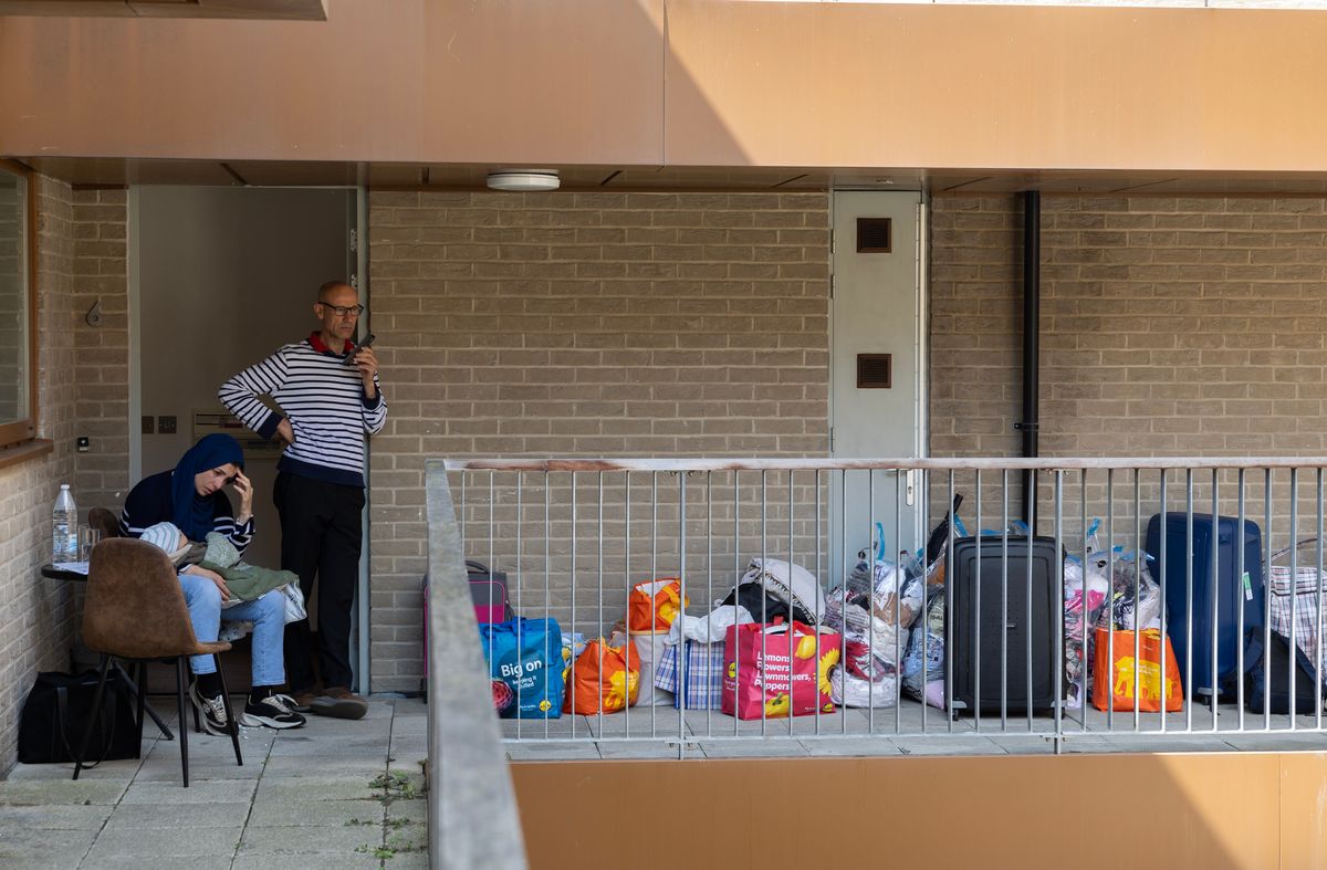 Fayza Bouyhia holds her eight-month-old baby after her family was evicted from their temporary accommodation at short notice