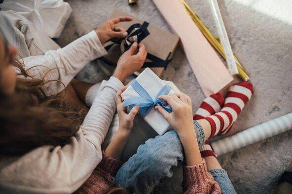 Family Gift Exchange: Cozy Holiday Moment With Wrapped Presents And Gift Ribbon