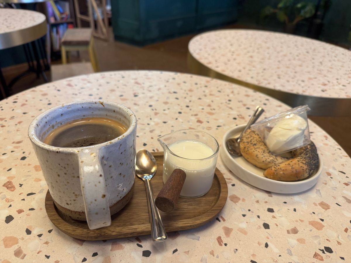 An Americano and poppy seed bagel with cream cheese at the Folklore café at Sutton Coldfield's railway station 