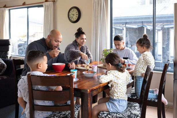 Family sitting around the dining table having breakfast