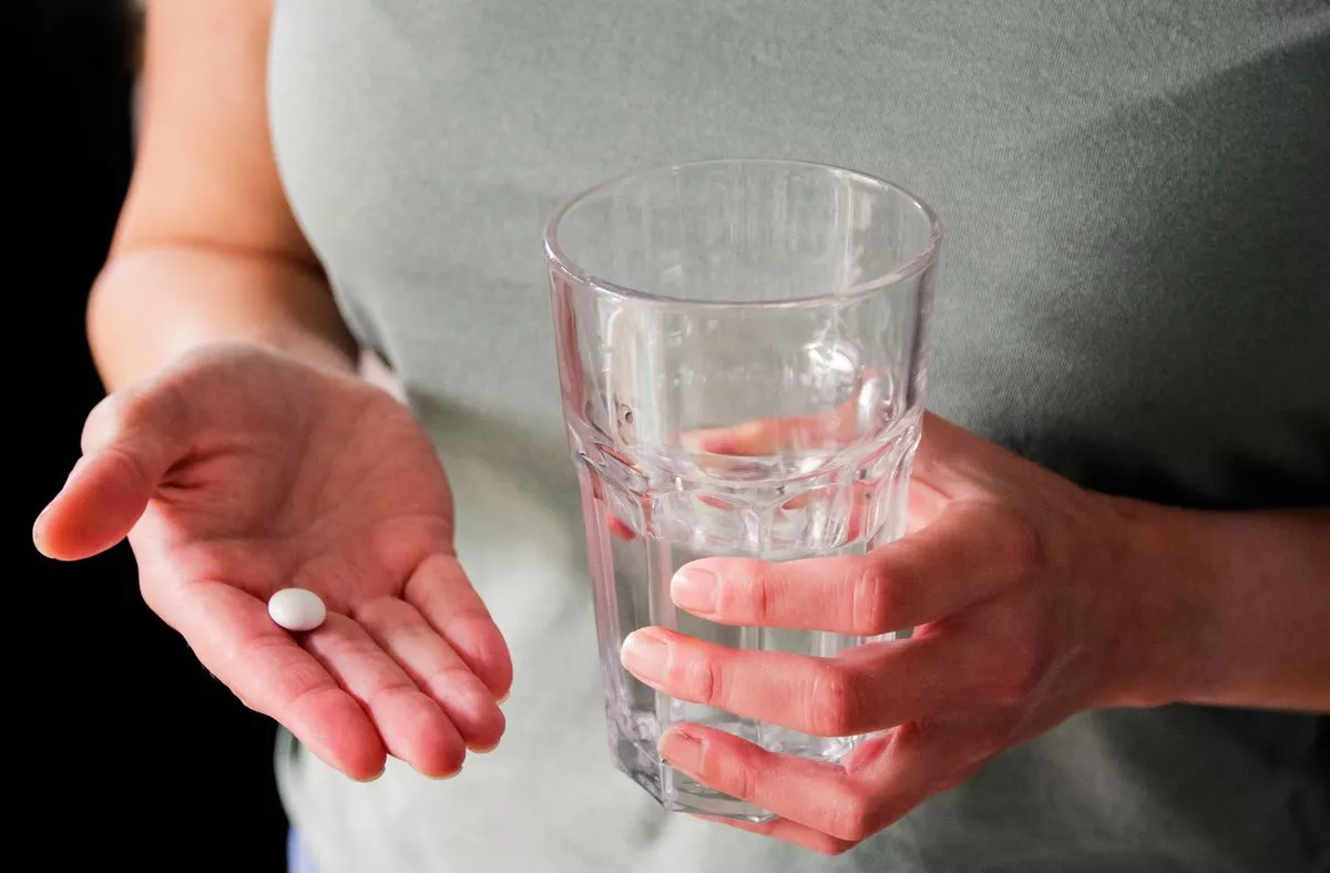 Taking pill, glass of water