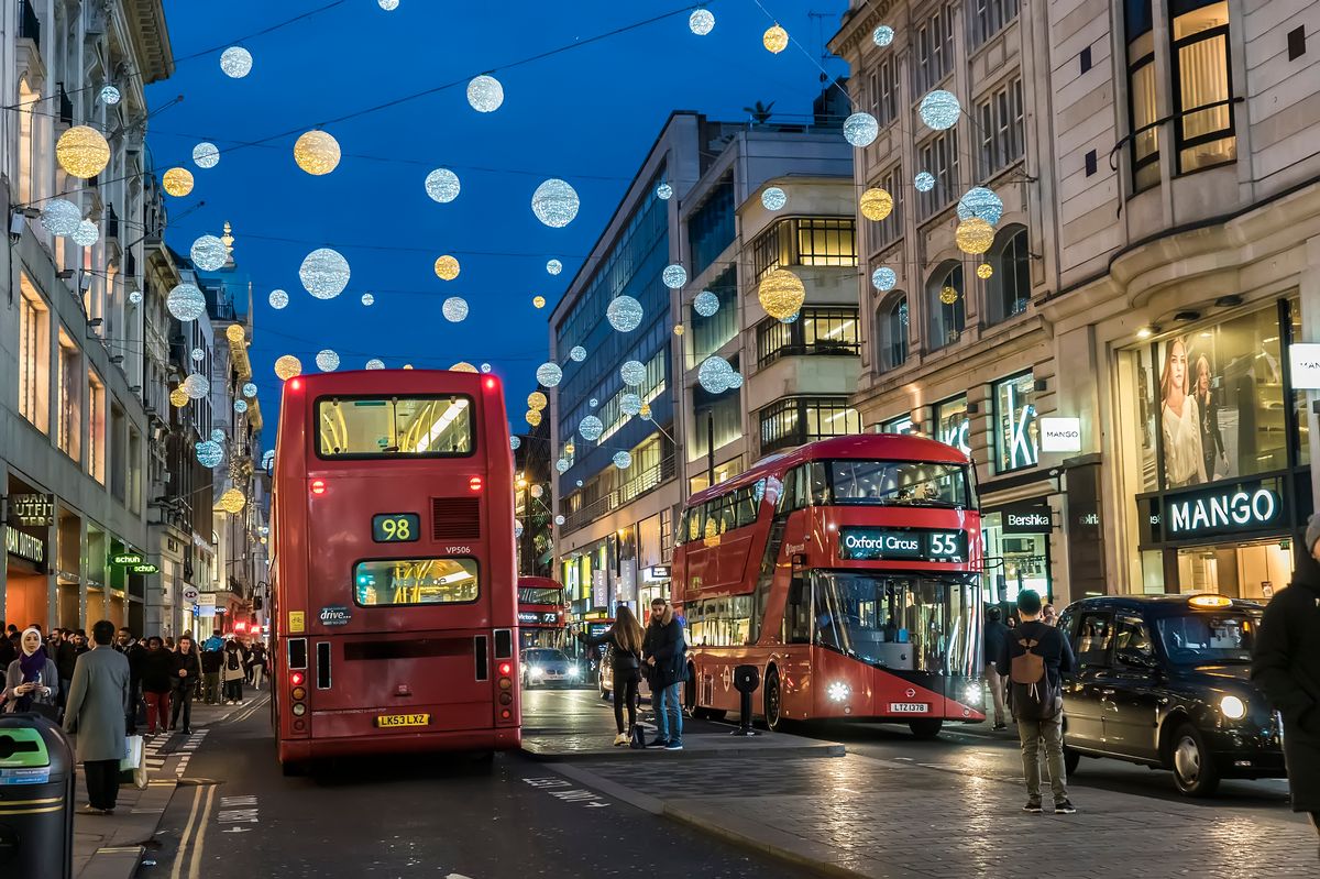 24.12.2016 London, UK Oxford Street in the evening, decorated with Christmas evening lights, before the New Year. Machines and taxis