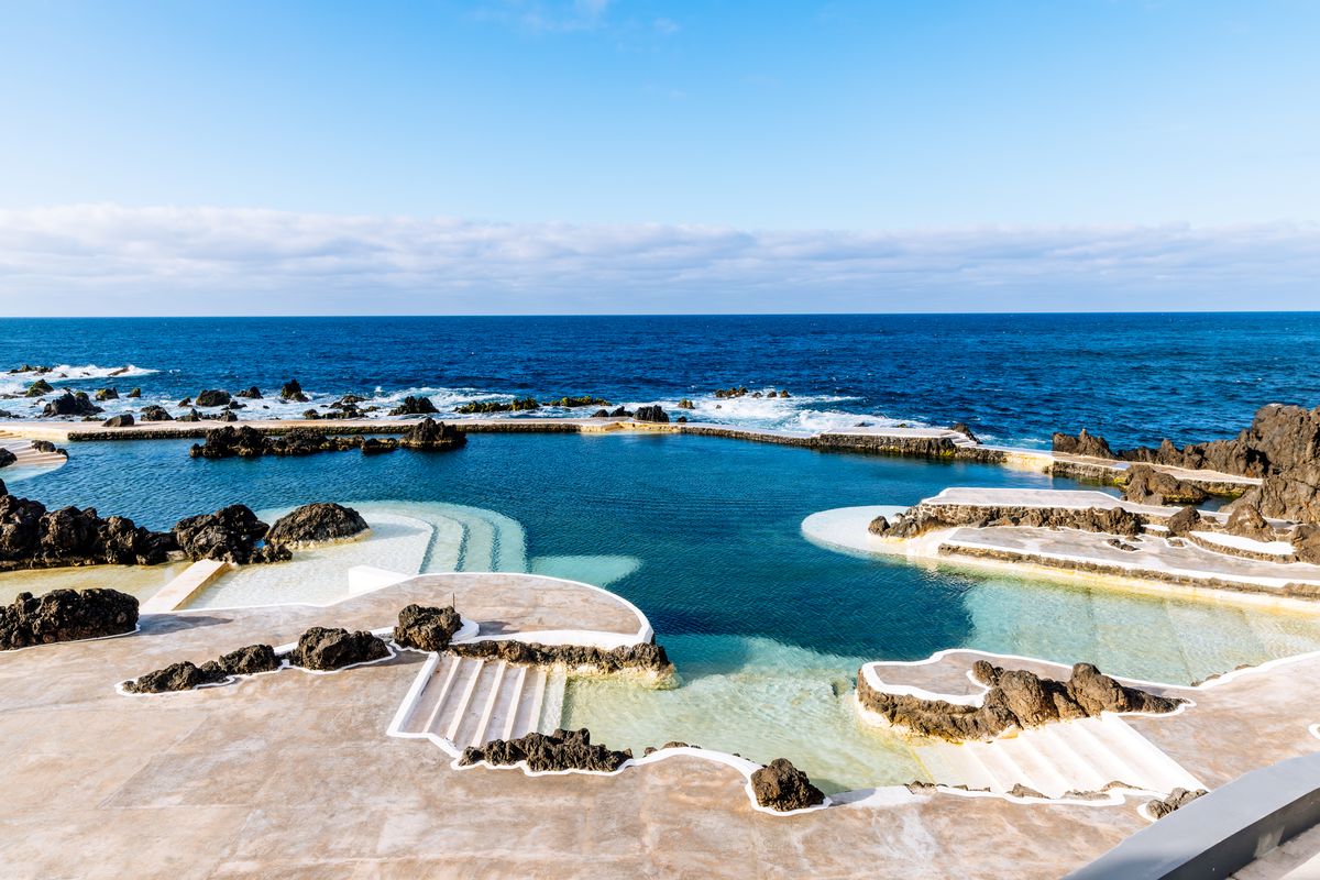 Public natural pool among rocks in Porto Moniz, Madeira Island, Portugal - stock photo