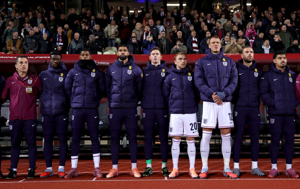 : Players of England line up for the national anthems