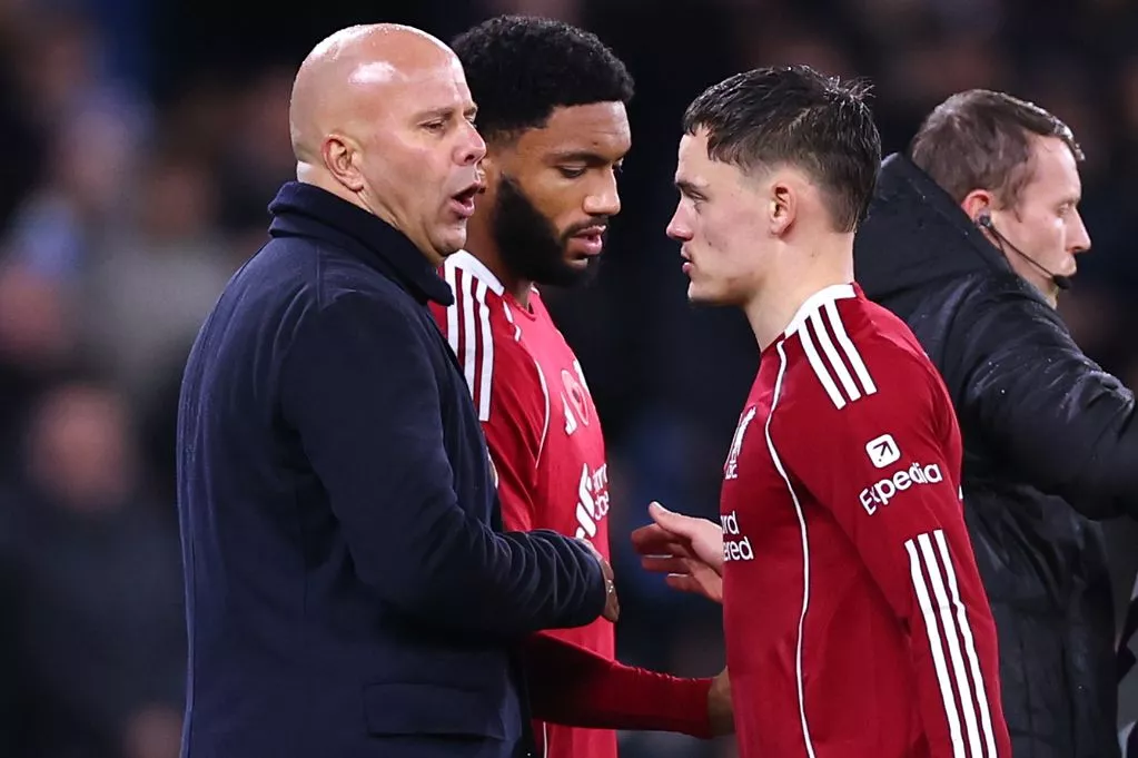 Arne Slot greets Florian Wirtz as he is substituted during Liverpool's game against Manchester City