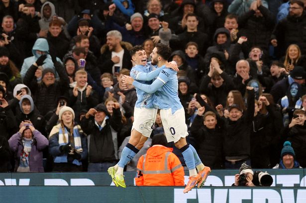 Phil Foden and Rayan Cherki celebrate Manchester City's third goal against Sunderland
