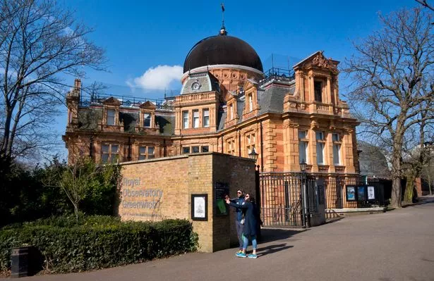 Two tourists outside the south building at The Royal Observatory, Greenwich