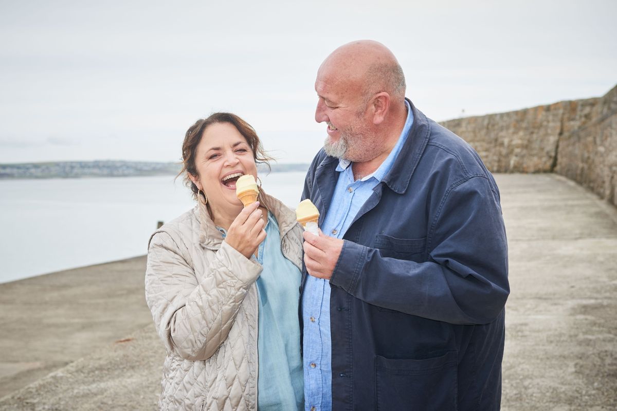 The image shows the pair on the beach tucking into an ice cream each