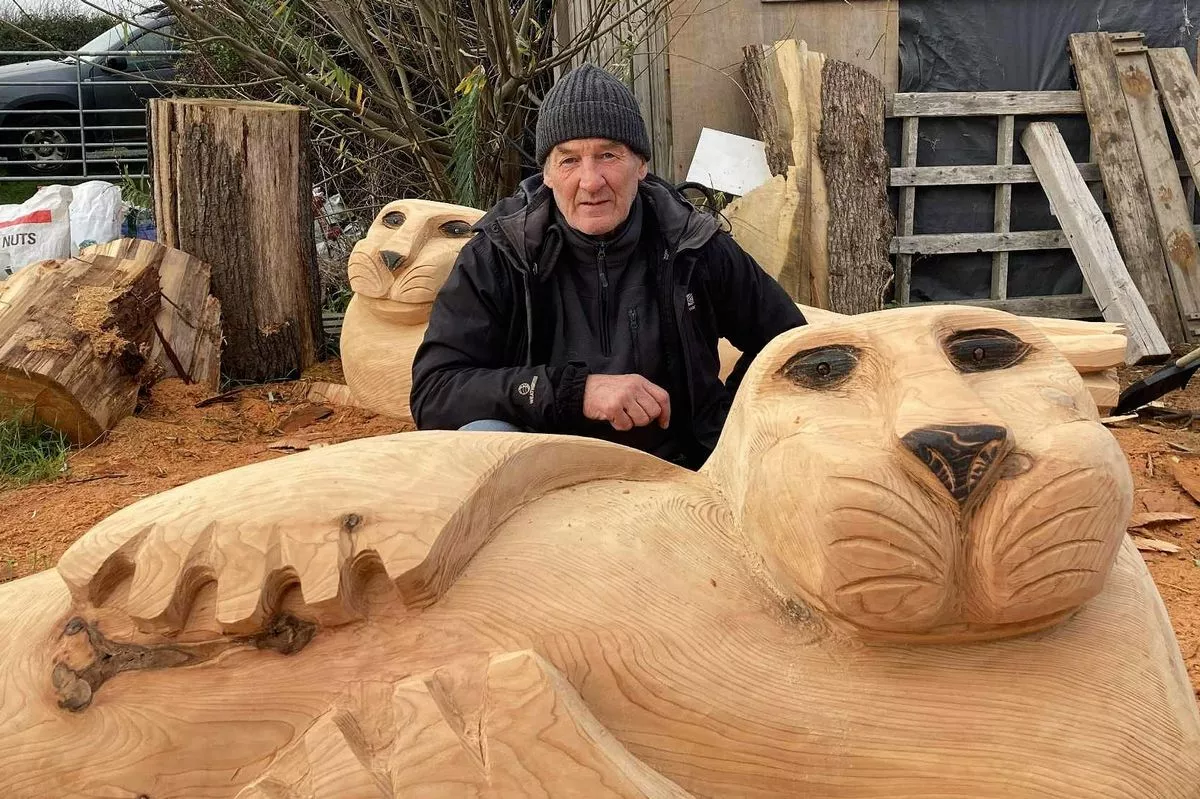 Wood sculptor Ste Iredale with the seals