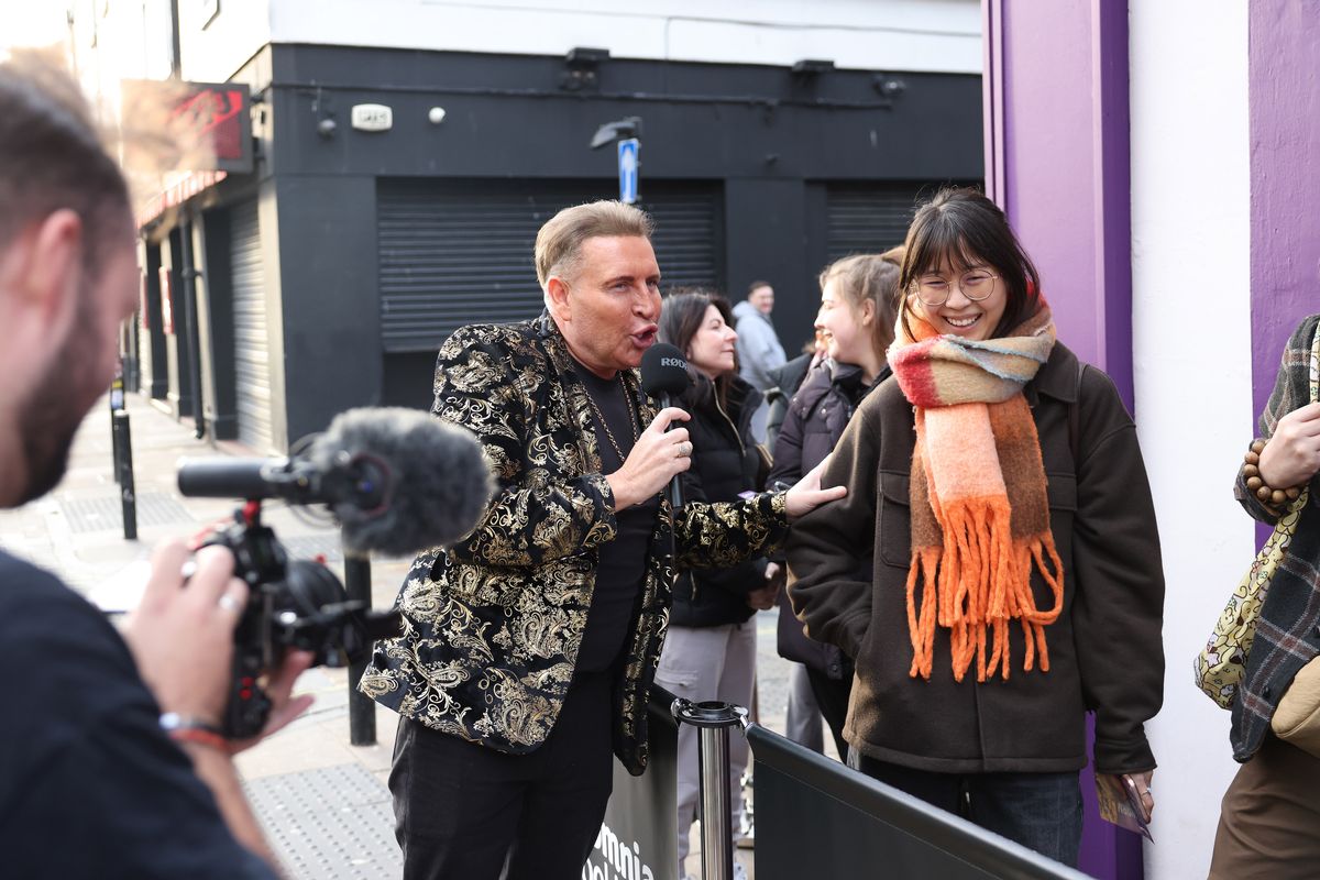 The Queen of Scottie Road speaks to costumers at Insomnia Cookies on Slater Street in Liverpool