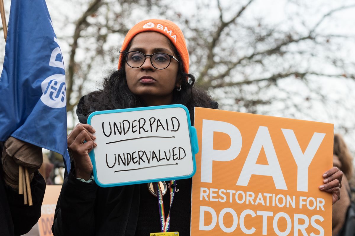 Resident doctors join a picket line outside St Thomas' Hospital in London on December 17