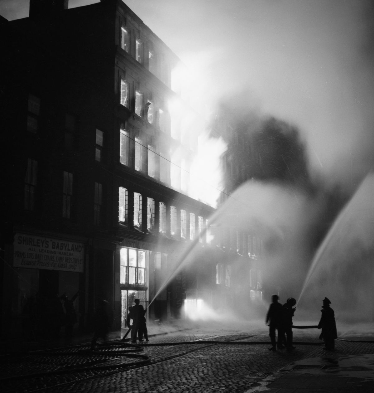 The Manchester Blitz, Buildings burning in Manchester after a German air raid in December 1940