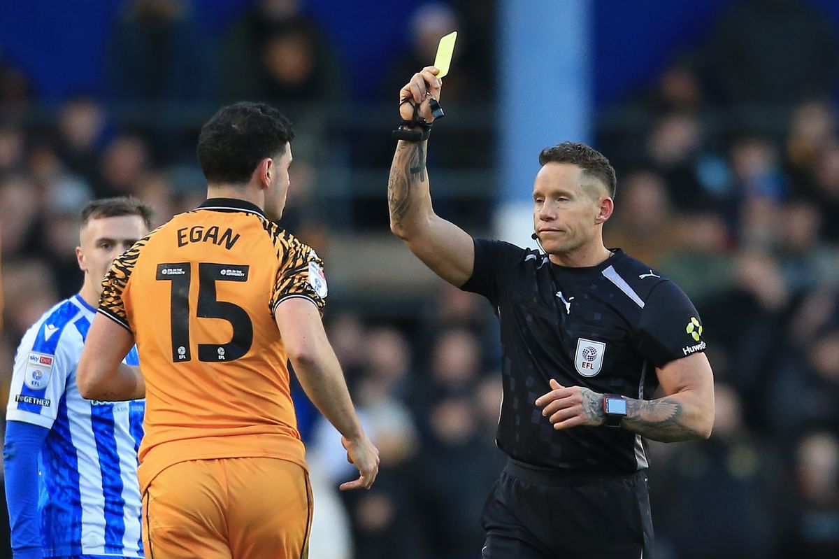 Referee Stephen Martin gives a yellow card to John Egan at Hillsborough